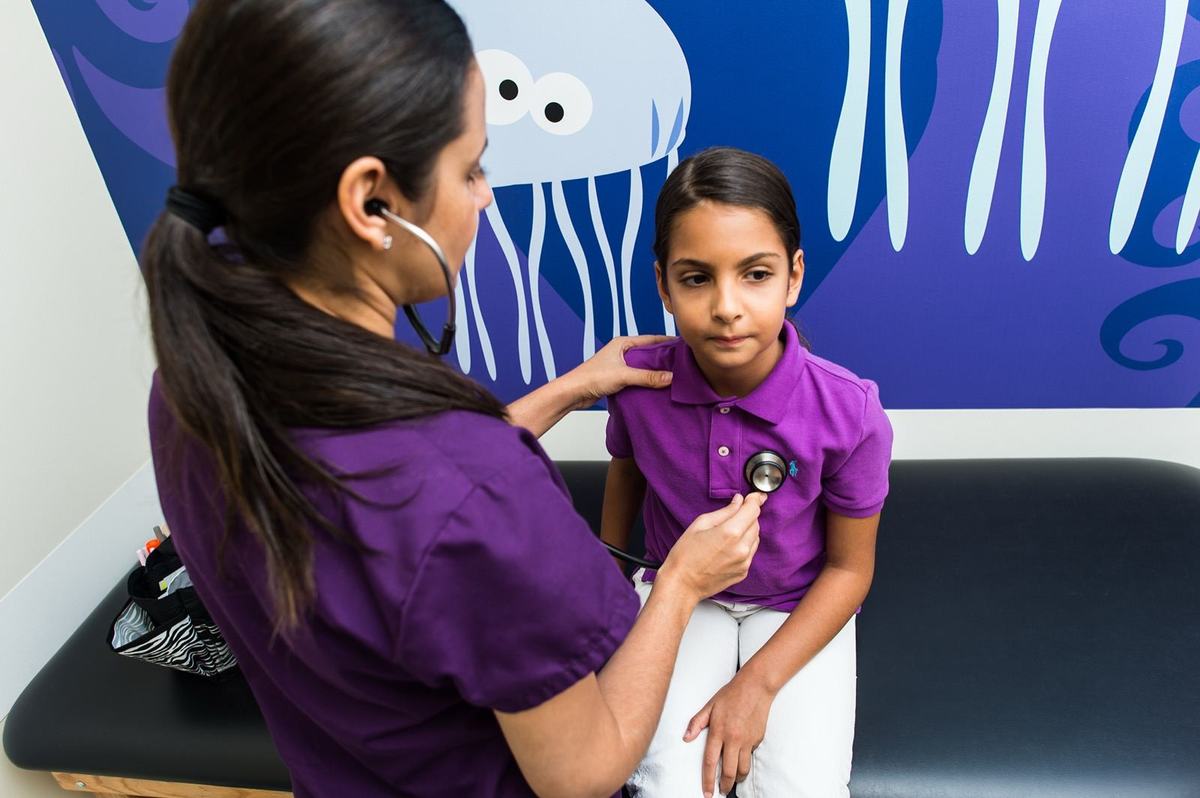 Pediatrician examining a young boy during a checkup at ABC Pediatric Clinic